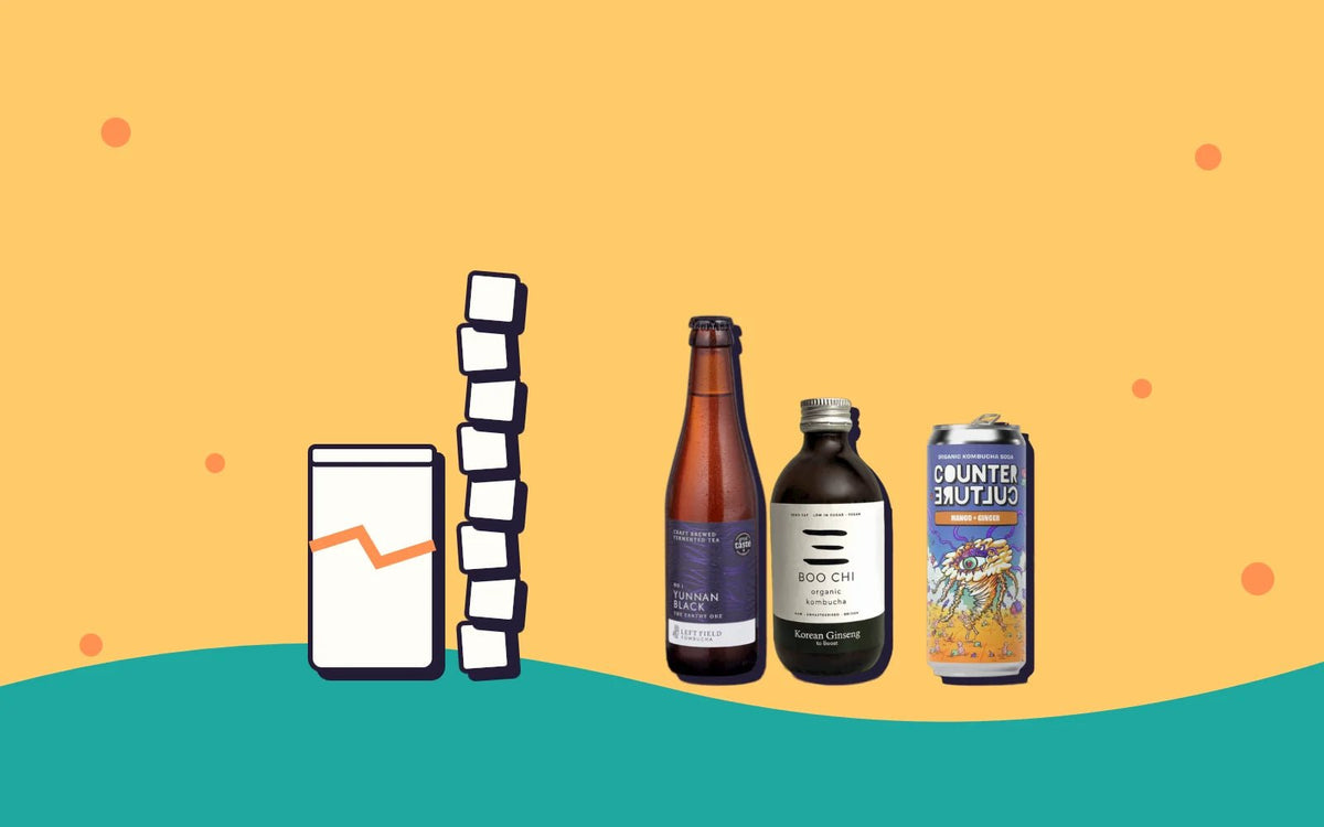 A tall stack of sugar cubes next to three bottles of kombucha