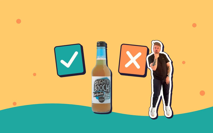 A bottle of Blighty Booch between a tick and a cross, with Kombucha Kev