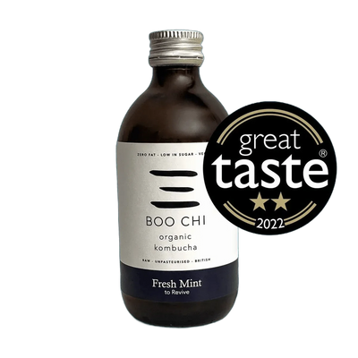Boo Chi Fresh Mint raw kombucha in an amber 330ml glass bottle with a silver cap and a white label with a navy flavour band, shown with its Great Taste 2022 award badge.