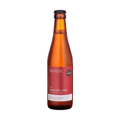 Left Field No.4 Darjeeling raw kombucha in a tall amber 330ml glass bottle with a black cap and a deep red swirl-patterned label.