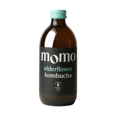 MOMO Elderflower raw kombucha in an amber glass bottle with a mint green cap and a black label with mint green lettering.