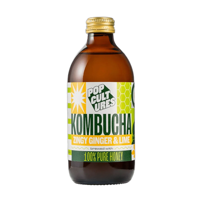 Pop Cultures Zingy Ginger & Lime raw jun kombucha in an amber 330ml glass bottle with a gold cap and a colourful lime green and yellow patchwork label.