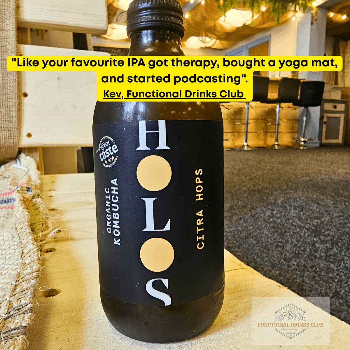 HOLOS Citra Hops raw kombucha on a table in the Otley taproom, with Kev's tasting note: "Like your favourite IPA got therapy, bought a yoga mat, and started podcasting."