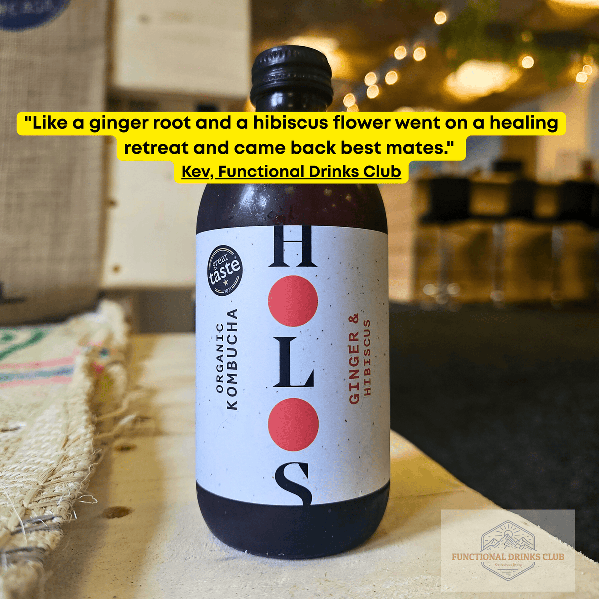 HOLOS Ginger & Hibiscus raw kombucha on a table in the Otley taproom, with Kev's tasting note.