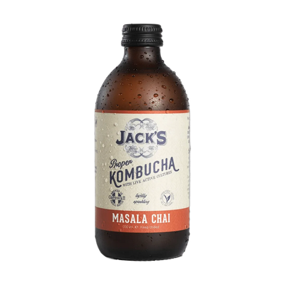 Jack's Masala Chai raw kombucha in an amber 330ml glass bottle with a black cap and a cream label with a burnt orange flavour band.