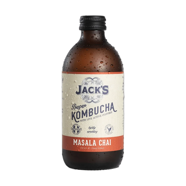 Jack's Masala Chai raw kombucha in an amber 330ml glass bottle with a black cap and a cream label with a burnt orange flavour band.