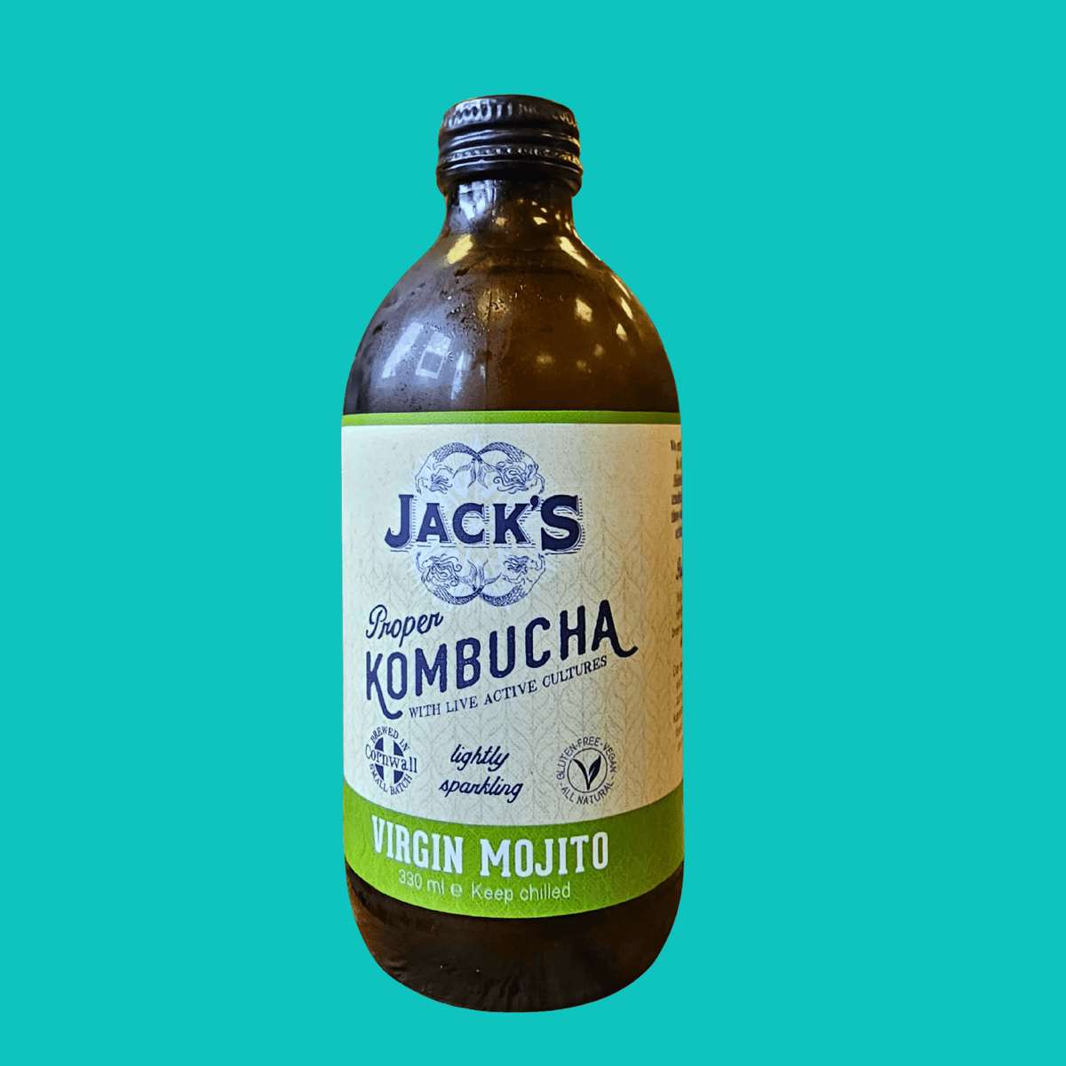 A bottle of Jack's Virgin Mojito raw kombucha on a teal background.