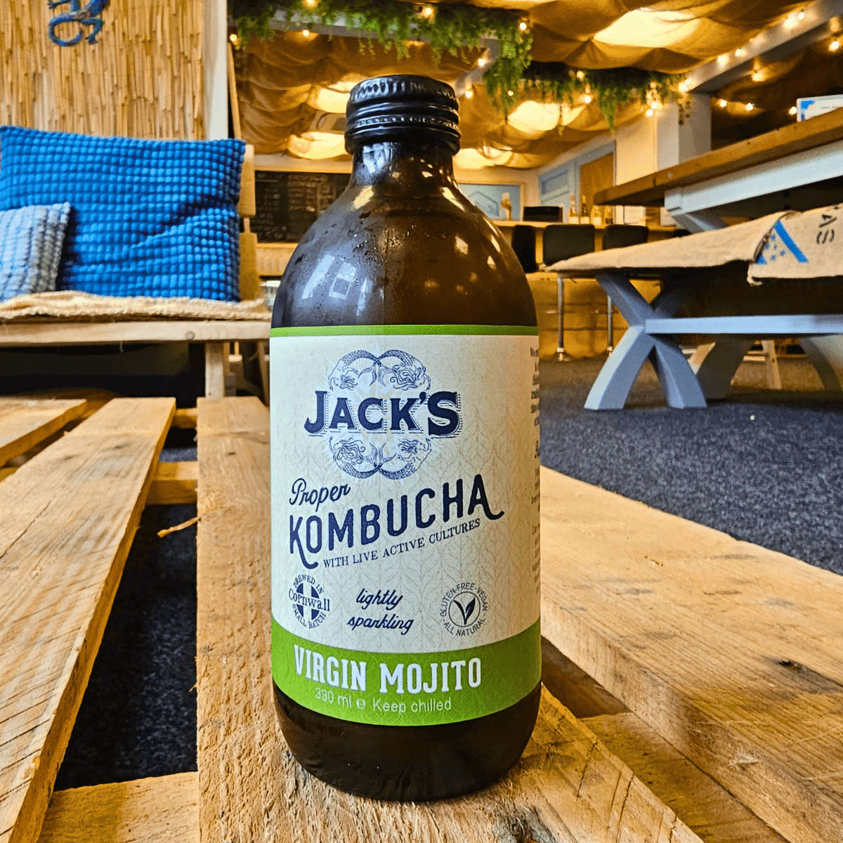 A bottle of Jack's Virgin Mojito raw kombucha on a wooden pallet table in the Otley taproom.