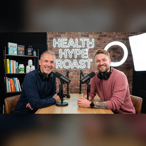 Kev and clinical nutritionist James Ellis at the mics under The Health Hype Roast neon sign