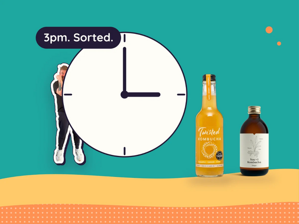 A clock at 3pm beside Twisted and You and I kombucha, with Kev standing by