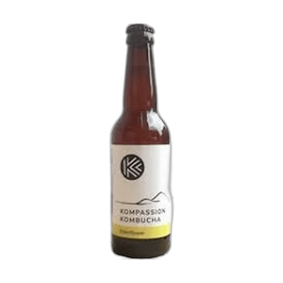 Kompassion Elderflower raw kombucha in a tall amber 330ml glass bottle with a black cap and a white label with a yellow flavour band.
