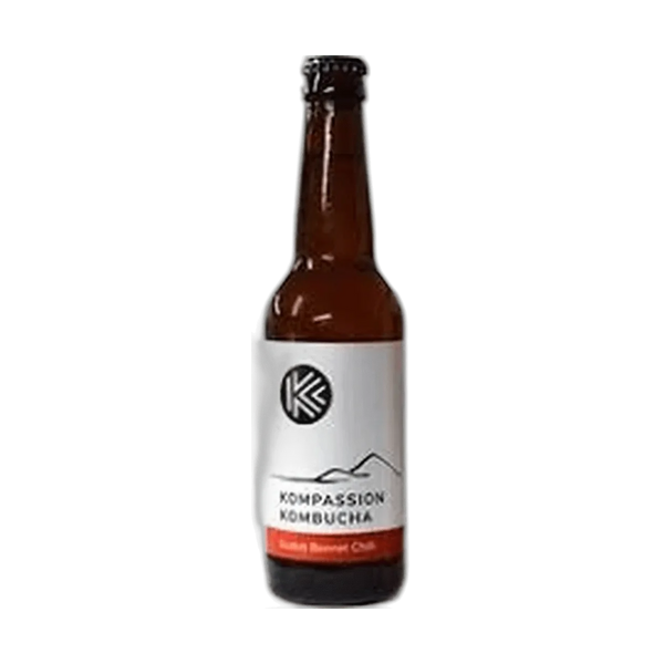 Kompassion Scotch Bonnet Chilli raw kombucha in a tall amber 330ml glass bottle with a black cap and a white label with a red flavour band.