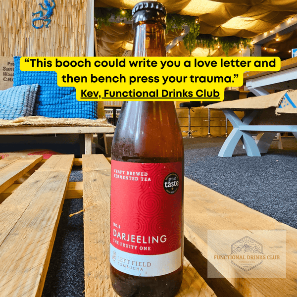Left Field No.4 Darjeeling raw kombucha on a wooden pallet table in the Otley taproom, with Kev's tasting note: "This booch could write you a love letter and then bench press your trauma."