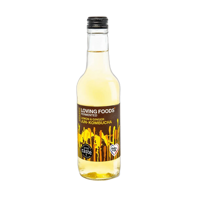 Loving Foods Lemon & Ginger raw jun kombucha in a clear 330ml glass bottle with a black cap and a dark brown label with yellow paint-drip artwork.
