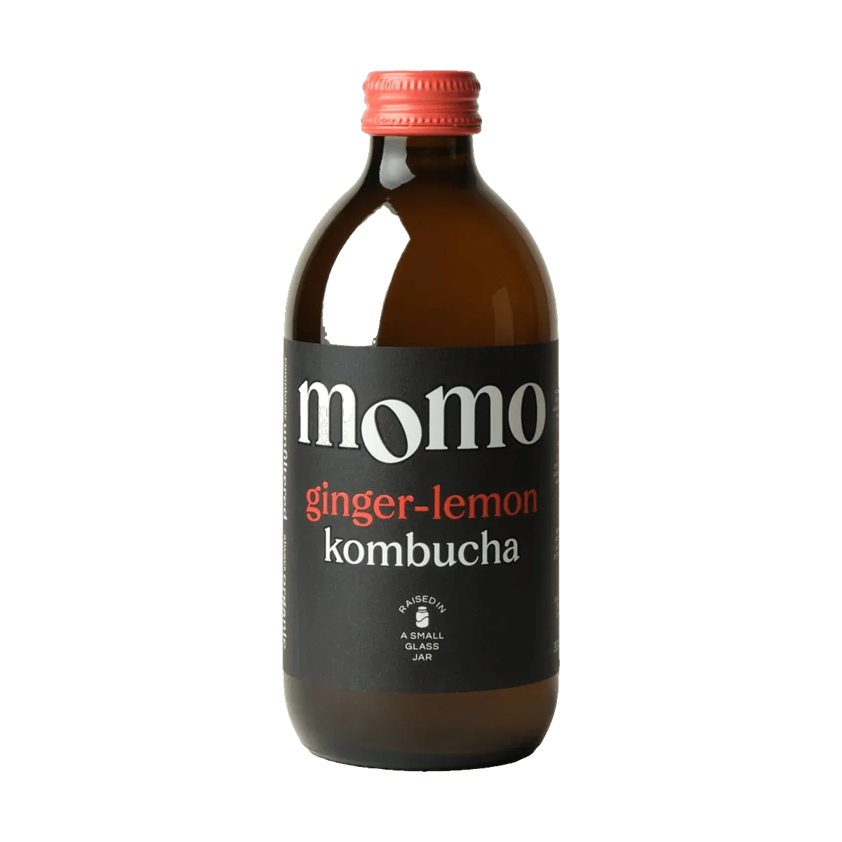 MOMO Ginger & Lemon raw kombucha in an amber glass bottle with a coral cap and a black label with coral lettering.