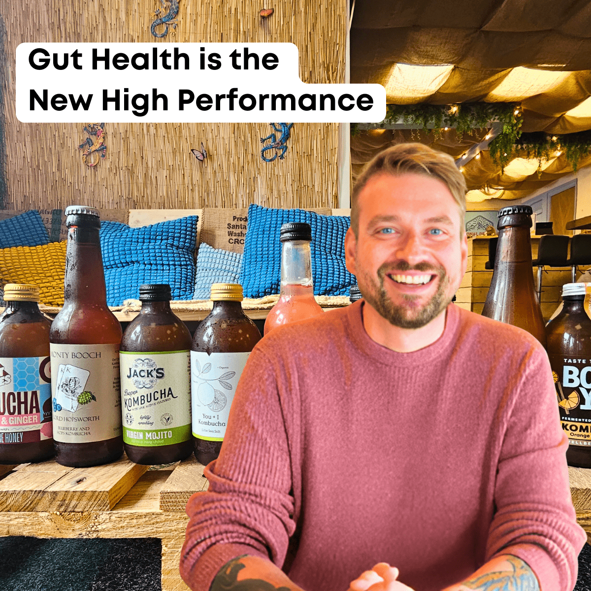 Kombucha Kev smiling at a table in the Otley taproom surrounded by bottles of raw kombucha, under the headline "Gut Health is the New High Performance".