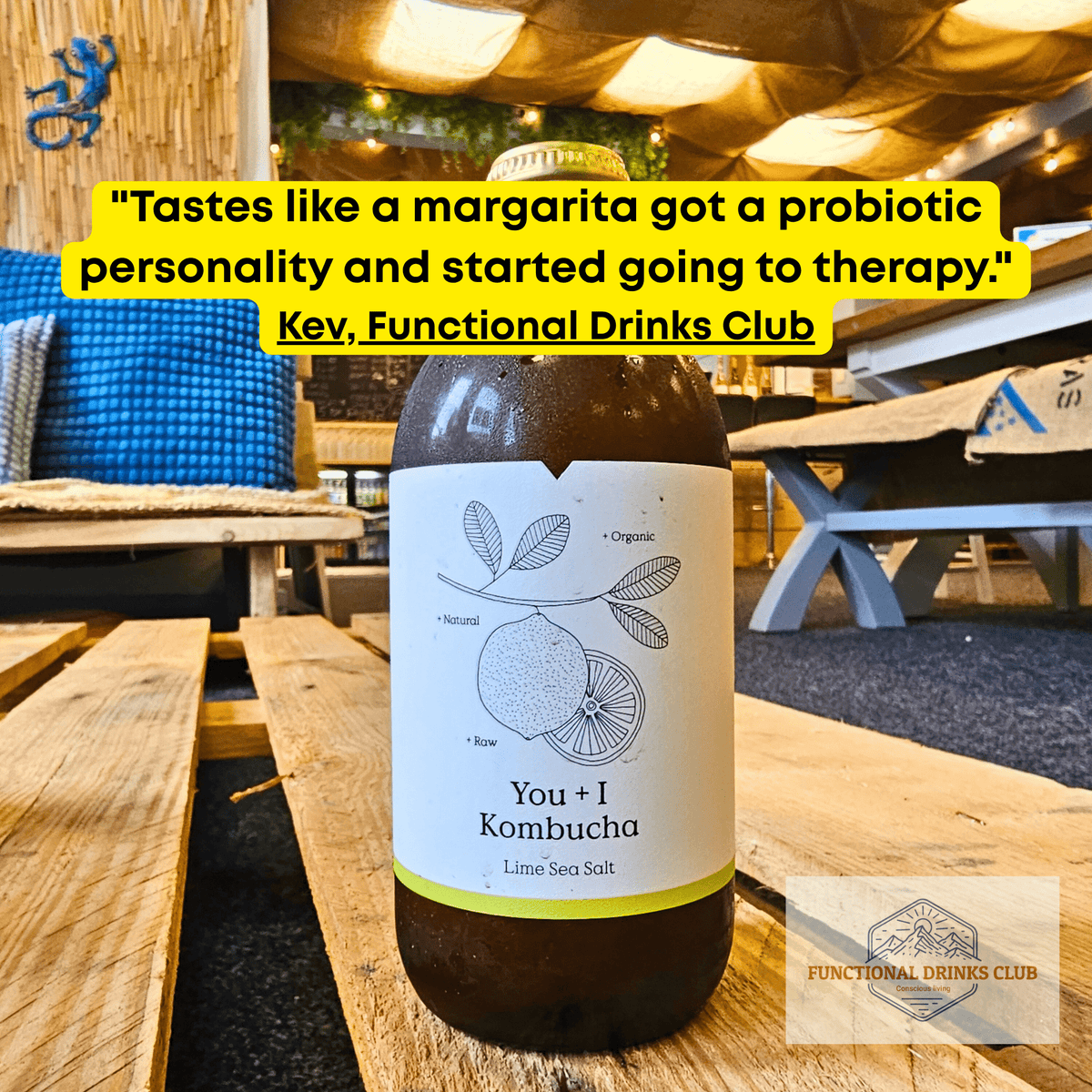 You + I Lime & Sea Salt raw kombucha on a wooden pallet table in the Otley taproom, with Kev's tasting note.