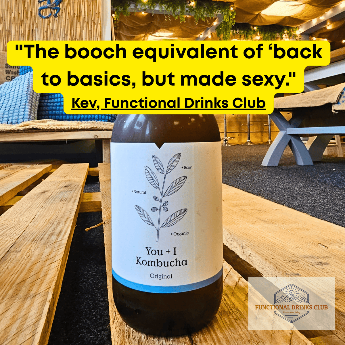You + I Original raw kombucha on a wooden pallet table in the Otley taproom, with Kev's tasting note: "The booch equivalent of 'back to basics, but made sexy.'"
